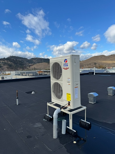 Cold climate heat pump mounted on a stand on a commercial roof in the Okanagan