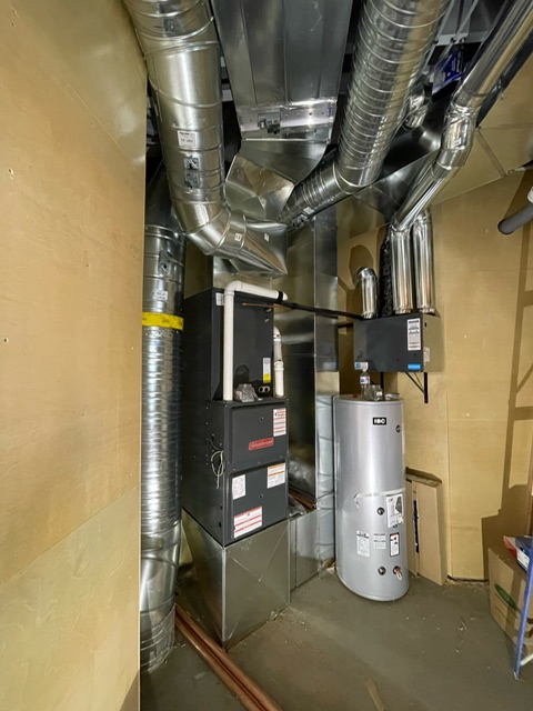 Furnace, ductwork and hot water tank installed together in a home mechanical room